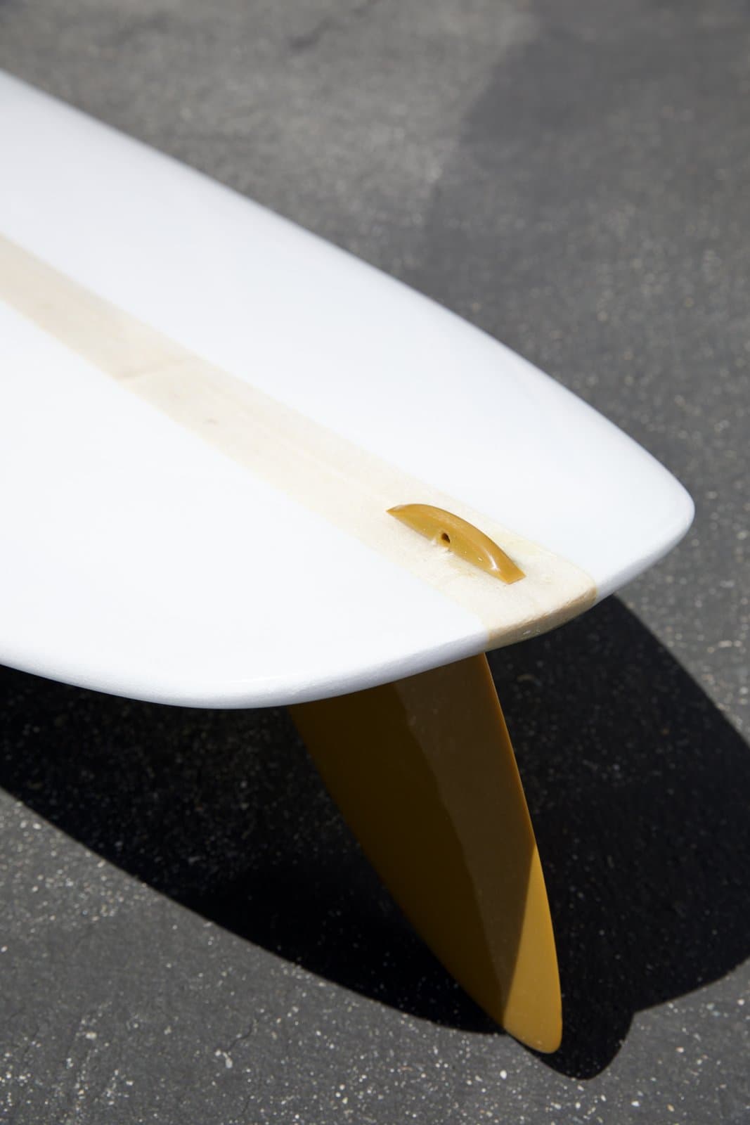 Glassed leash loop on the deck of a Lundquist longboard